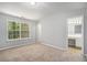 Bright bedroom with carpet, a large window, and an en-suite bathroom for added convenience at 1728 Devon Sw Dr, Atlanta, GA 30311