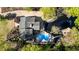 Stunning aerial view of home with dark roof, beautiful landscaping, and a kidney shaped inground swimming pool at 2750 Interlaken Dr, Marietta, GA 30062
