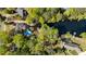 Aerial view of a private backyard oasis with mature trees, a pond and dock, and a sparkling blue swimming pool at 2750 Interlaken Dr, Marietta, GA 30062