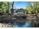 Expansive backyard featuring a large pond, waterfall, mature trees, and outdoor living spaces at 2750 Interlaken Dr, Marietta, GA 30062
