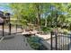 Beautiful backyard with a brick patio, waterfall feature, lush landscaping, and wrought iron fencing at 2750 Interlaken Dr, Marietta, GA 30062