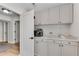 Butler's pantry featuring light gray cabinetry, white marble countertop, and coffee machine at 2750 Interlaken Dr, Marietta, GA 30062