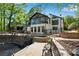 Stunning exterior of a modern home with a waterfall, brick patio, and floor-to-ceiling windows at 2750 Interlaken Dr, Marietta, GA 30062