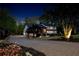 Elegant home at night with a brick driveway, well-manicured landscaping, and a cozy, inviting ambiance at 2750 Interlaken Dr, Marietta, GA 30062