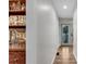 Hallway view of the wet bar that includes glassware and wood cabinets leading to an exit at 2750 Interlaken Dr, Marietta, GA 30062