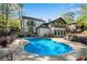 Backyard pool with brick patio, outdoor seating, lush greenery, and exterior view of a modern home at 2750 Interlaken Dr, Marietta, GA 30062