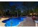 Relaxing in-ground pool at night with a brick patio, lounge seating, and lush landscaping, perfect for entertaining at 2750 Interlaken Dr, Marietta, GA 30062