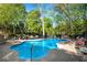 Gorgeous backyard pool with a brick patio, lounge chairs, mature trees, and wrought iron fencing at 2750 Interlaken Dr, Marietta, GA 30062