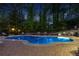 Inviting in-ground pool at night with brick patio and stylish lounge seating, perfect for relaxation and entertaining at 2750 Interlaken Dr, Marietta, GA 30062