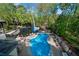 Stunning backyard oasis featuring a gunite pool with lush landscaping and serene lake views at 2750 Interlaken Dr, Marietta, GA 30062