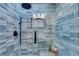 Tiled walk-in shower highlighting glass doors, rainfall showerhead, and tiled walls at 2750 Interlaken Dr, Marietta, GA 30062