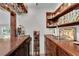Convenient wet bar featuring wooden cabinets, glassware storage, and a mini refrigerator at 2750 Interlaken Dr, Marietta, GA 30062