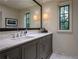 Bathroom with a marble countertop, gray cabinets, and a large mirror at 2979 Ridgewood Nw Rd, Atlanta, GA 30327
