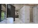 Luxurious bathroom featuring a freestanding tub, marble shower, and neutral decor at 2979 Ridgewood Nw Rd, Atlanta, GA 30327