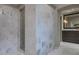 Bathroom showcasing marble tile walls, a glass shower, and a vanity with a large mirror at 2979 Ridgewood Nw Rd, Atlanta, GA 30327