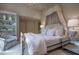 Cozy bedroom with a beautiful chandelier, neutral colors, comfortable chair, and a luxurious canopy bed at 2979 Ridgewood Nw Rd, Atlanta, GA 30327
