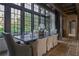 Elegant dining area with a long table, comfortable chairs, and large windows offering beautiful views at 2979 Ridgewood Nw Rd, Atlanta, GA 30327