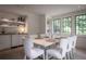 Elegant dining room with wainscoting, built-in shelves, and large windows overlooking a green landscape at 2979 Ridgewood Nw Rd, Atlanta, GA 30327