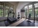 Well-equipped home gym with treadmill, weight rack, and large windows providing natural light and backyard views at 2979 Ridgewood Nw Rd, Atlanta, GA 30327