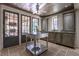 Light-filled kitchen area boasts an island, custom cabinets, and seamless access to the outdoor patio through French doors at 2979 Ridgewood Nw Rd, Atlanta, GA 30327