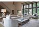 Bright and airy living room featuring high ceilings, large windows, and stylish neutral-toned furnishings at 2979 Ridgewood Nw Rd, Atlanta, GA 30327