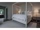 Well-lit main bedroom featuring a four-poster bed, accent chair, and neutral decor at 2979 Ridgewood Nw Rd, Atlanta, GA 30327