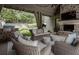 Inviting outdoor living area featuring a stone fireplace, grill, ample seating, and serene backyard views at 2979 Ridgewood Nw Rd, Atlanta, GA 30327