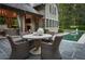 Beautiful outdoor dining area next to the pool, featuring comfortable wicker chairs and stone accents at 2979 Ridgewood Nw Rd, Atlanta, GA 30327