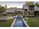 Stunning rear exterior showcasing a modern pool, lush lawn, and elegant architecture at 2979 Ridgewood Nw Rd, Atlanta, GA 30327