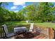 Outdoor deck with chairs and table overlooking grassy backyard with storage shed at 363 Arnold Mill Rd, Woodstock, GA 30188