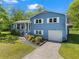 Inviting two-story blue home with a well-maintained lawn and an attached one car garage at 363 Arnold Mill Rd, Woodstock, GA 30188