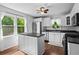 Bright kitchen with stainless steel appliances, white cabinets, and a view to the outdoors at 363 Arnold Mill Rd, Woodstock, GA 30188