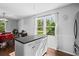 Bright kitchen island with views of the outside that brings in natural light and showcases a dining area at 363 Arnold Mill Rd, Woodstock, GA 30188