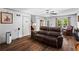 Spacious living room featuring hardwood floors, ceiling fan, and comfortable seating area at 363 Arnold Mill Rd, Woodstock, GA 30188
