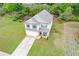 Aerial view of a two-story home showcasing a well-manicured front lawn and spacious driveway at 74 Macland Mill Ln, Dallas, GA 30157