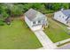 Aerial shot of two-story home with a spacious yard, long driveway, and two-car garage at 74 Macland Mill Ln, Dallas, GA 30157