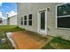The backyard features a concrete patio, windows, green grass, and is surrounded by lush landscaping at 74 Macland Mill Ln, Dallas, GA 30157