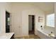 Bright bathroom featuring a soaking tub, walk-in closet, and neutral color scheme at 74 Macland Mill Ln, Dallas, GA 30157