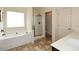 Relaxing bathroom featuring a soaking tub, walk-in shower, and double vanity at 74 Macland Mill Ln, Dallas, GA 30157