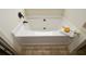A close up of a soaking tub with neutral wall paint and tile flooring at 74 Macland Mill Ln, Dallas, GA 30157