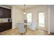 Cozy breakfast nook featuring tile floors, a glass table with seating, and a view of the backyard at 74 Macland Mill Ln, Dallas, GA 30157