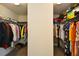 A walk-in closet with clothing on both sides of the space at 74 Macland Mill Ln, Dallas, GA 30157