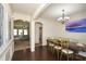 Dining room with dark wood floors, chandelier, and a formal dining table adjacent to the Living Room at 74 Macland Mill Ln, Dallas, GA 30157