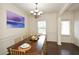Bright dining room featuring a dark wood table, modern chandelier, and elegant wall decor at 74 Macland Mill Ln, Dallas, GA 30157