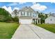 Two-story home with an attached two-car garage, long driveway and grassy front lawn at 74 Macland Mill Ln, Dallas, GA 30157