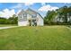 Two-story home with a large grassy front yard, long driveway and an attached two-car garage at 74 Macland Mill Ln, Dallas, GA 30157
