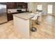 Bright kitchen featuring granite countertops, an island with seating, and tile flooring at 74 Macland Mill Ln, Dallas, GA 30157