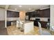 Open kitchen boasts granite countertops, a central island with seating, and dark cabinetry at 74 Macland Mill Ln, Dallas, GA 30157
