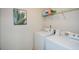 Functional laundry room with washer, dryer, and storage shelf at 74 Macland Mill Ln, Dallas, GA 30157