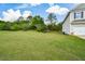 Large grassy lawn with a two-story home, and an attached two-car garage in the background at 74 Macland Mill Ln, Dallas, GA 30157